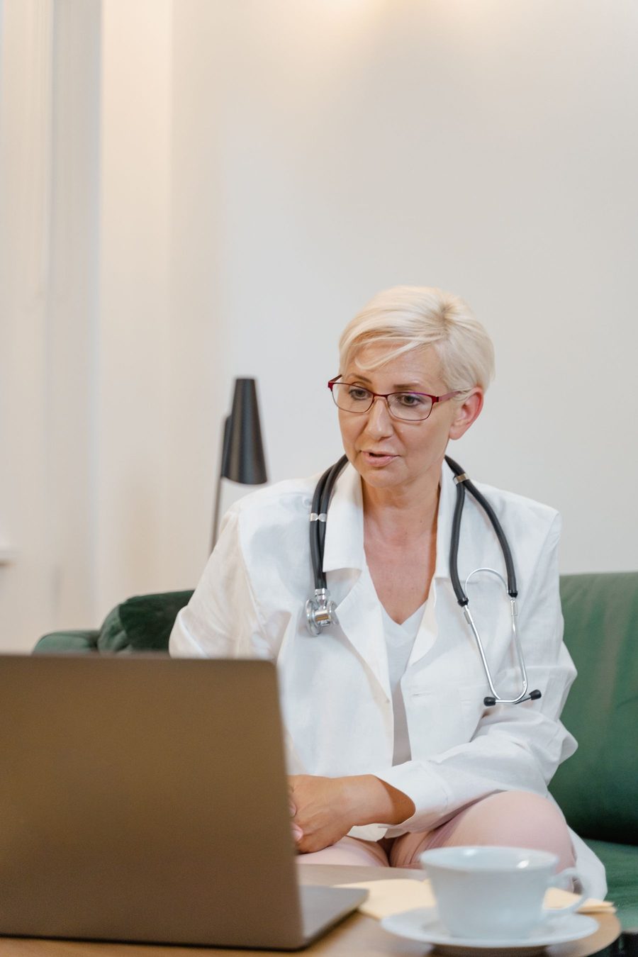 A physician running a telehealth visit from a laptop